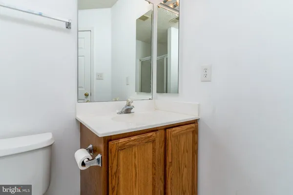 a bathroom with a sink toilet and mirror
