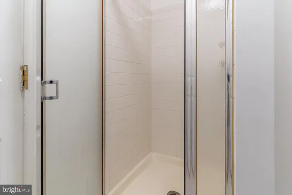 a bathroom with a glass shower door