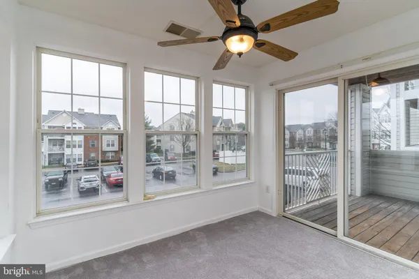 a living room with hardwood floor and windows