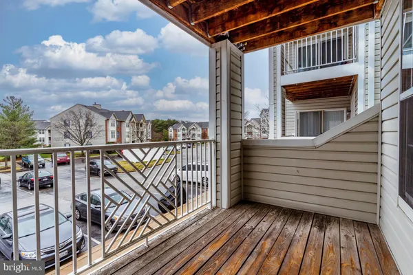 a view of a balcony with wooden floor and city view