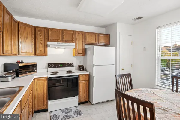 a kitchen with sink a stove and refrigerator