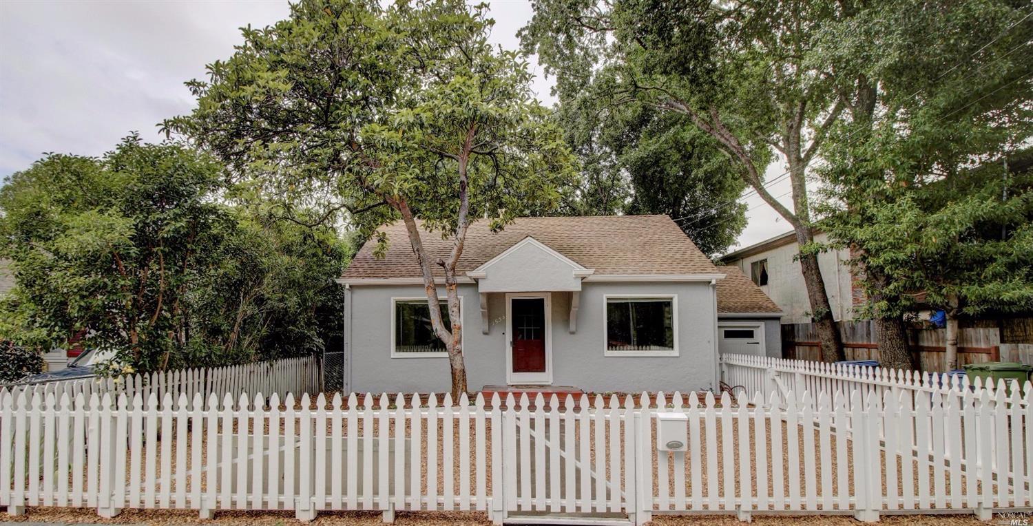a house that has a tree in front of it