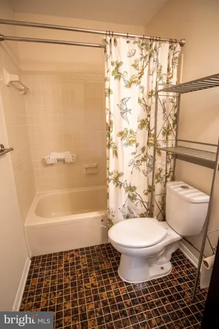 a bathroom with a sink toilet a mirror and shower