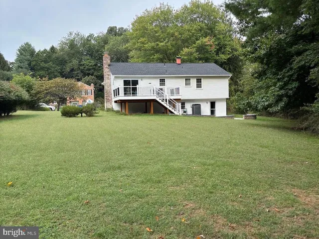 a front view of a house with a garden and yard