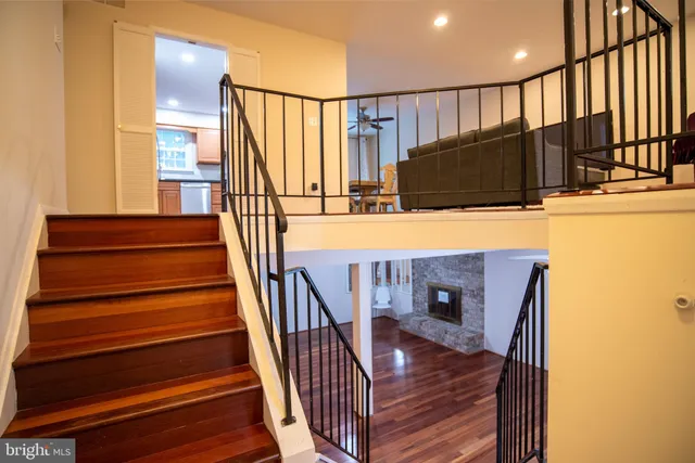 a view of entryway and hall with wooden floor