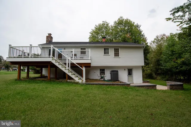 a view of a house with a yard and sitting area
