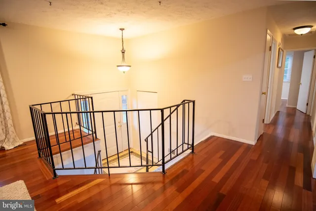 a view of a room with wooden floor