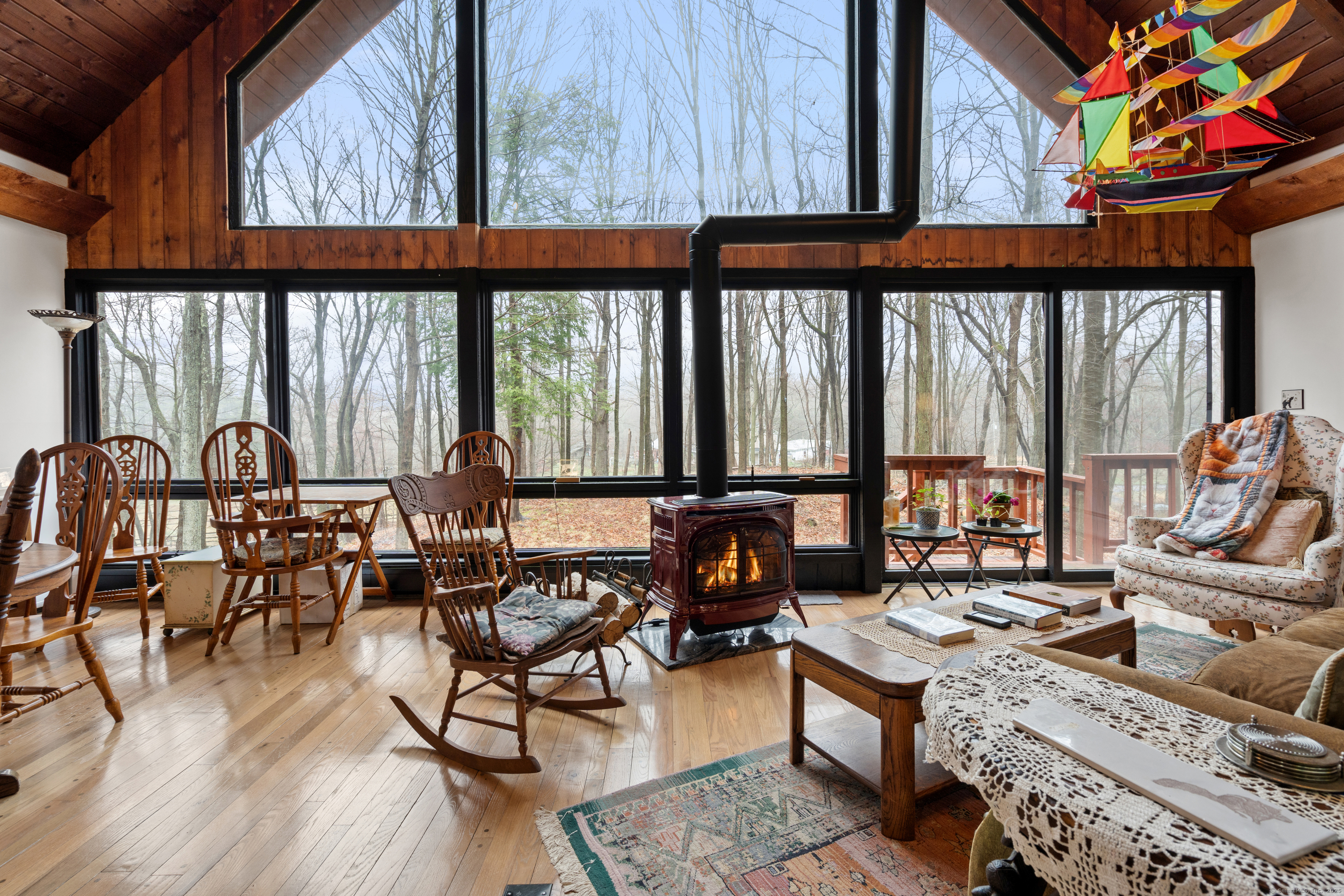 an outdoor living room with furniture and floor to ceiling windows