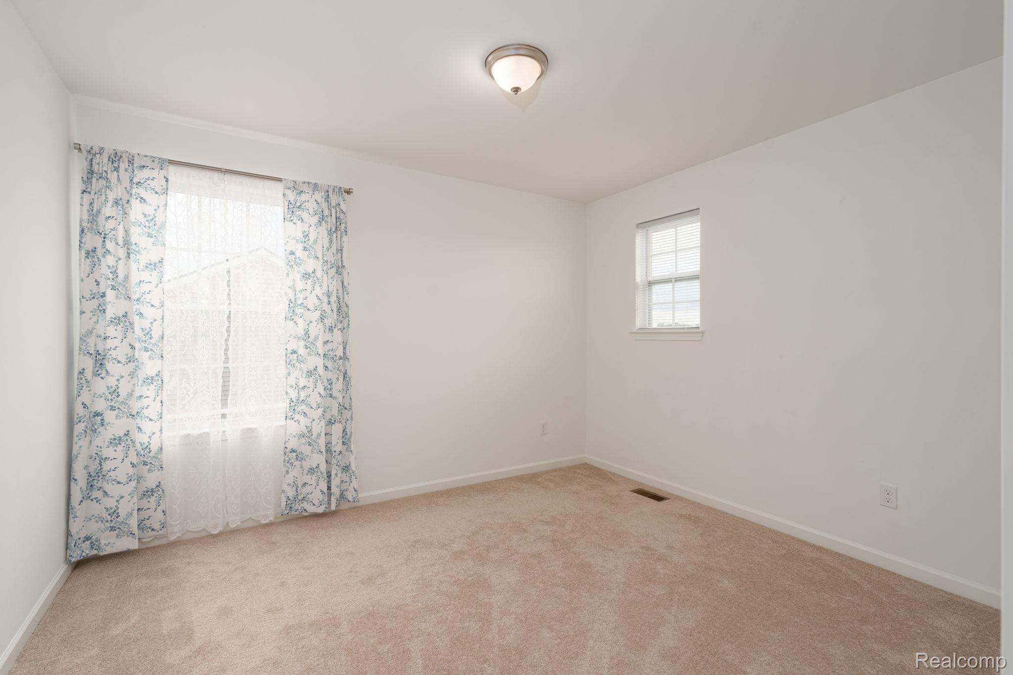 48904 Carnegie Way Macomb, MI 48042 - Photo 27 of 34 Room featuring neutral-toned carpeting, white walls, and a semi-flush mount ceiling light
