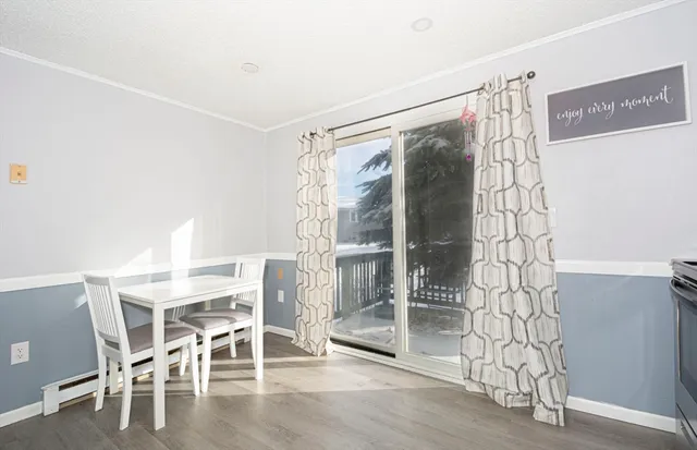 a dining room with furniture and wooden floor