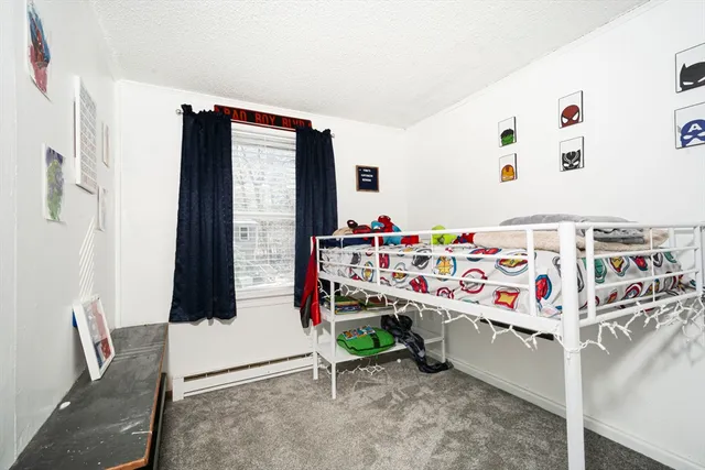 a utility room with stainless steel appliances refrigerator and toys