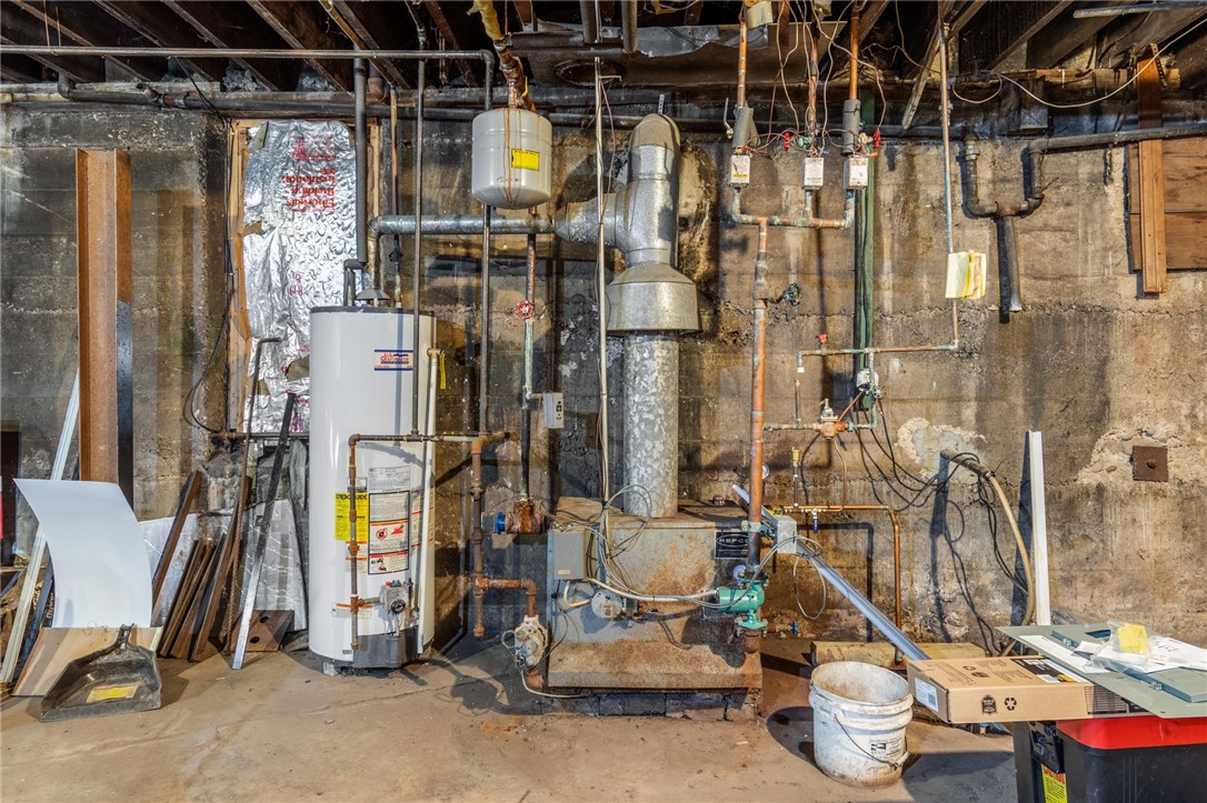 4075 Ridge Road Williamson, NY 14589 - Photo 26 of 37 The boiler and water heater in the basement