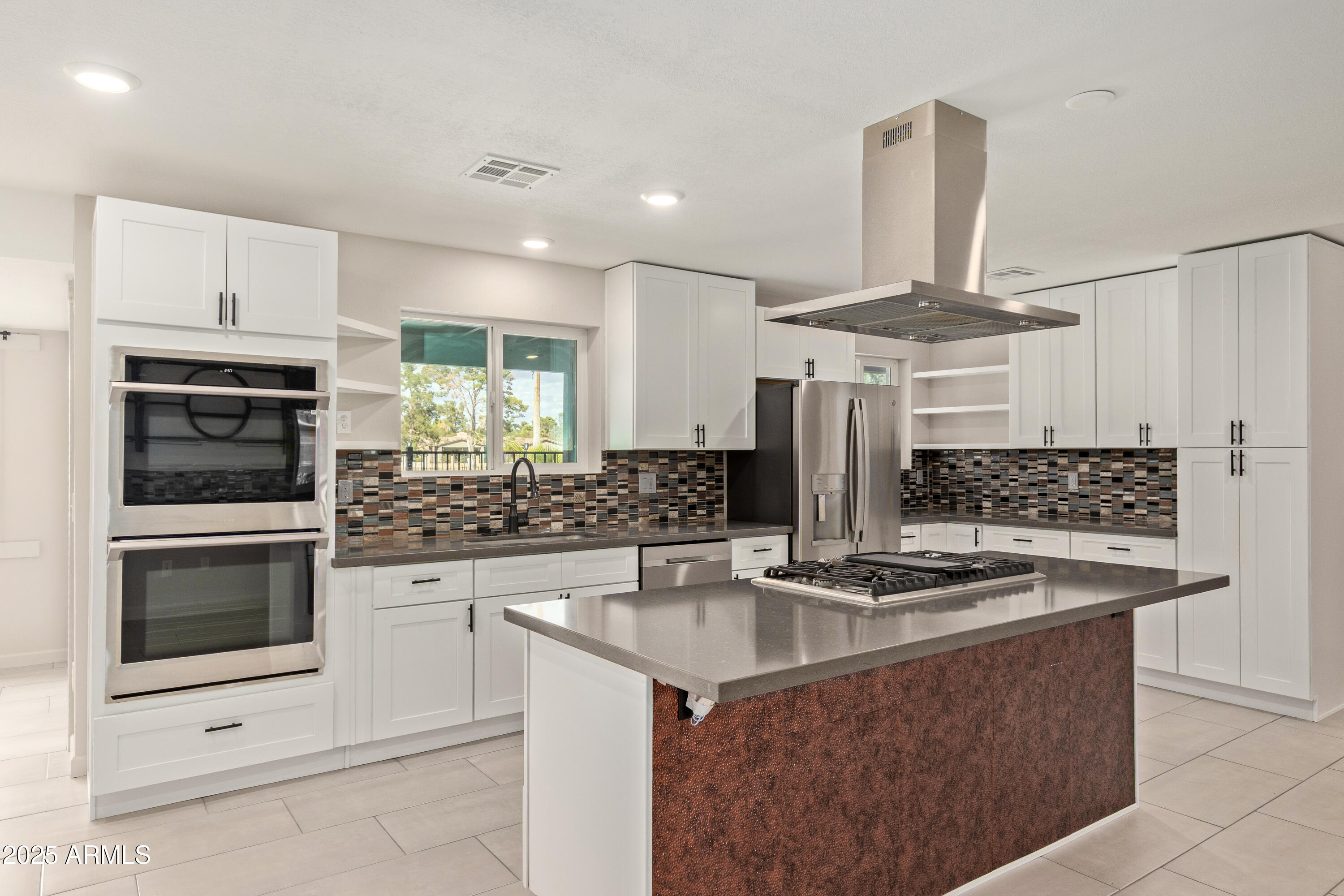 302 West Thunderbird Road Phoenix, AZ 85023 - Photo 12 of 44 a kitchen with stainless steel appliances granite countertop a sink stove and refrigerator