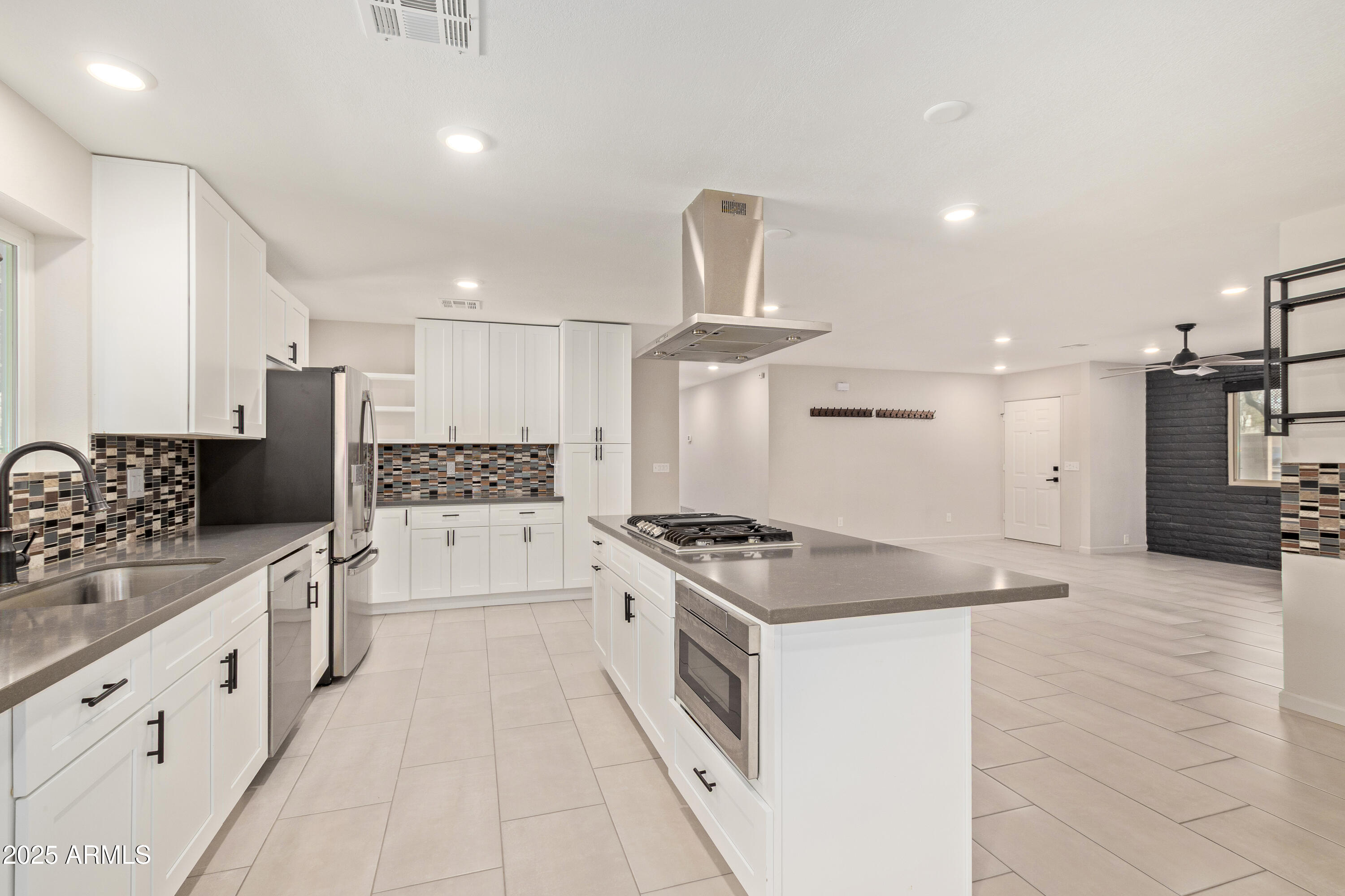 302 West Thunderbird Road Phoenix, AZ 85023 - Photo 14 of 44 a kitchen with white cabinets and appliances
