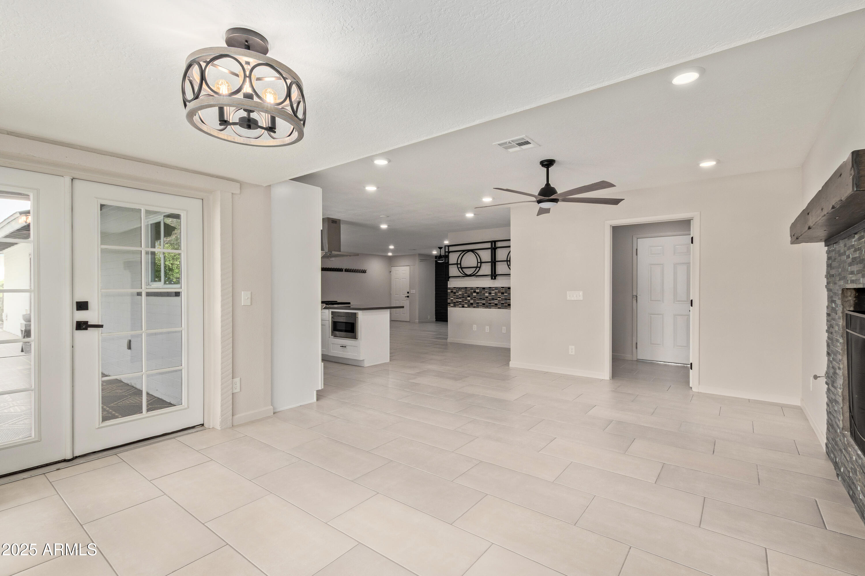302 West Thunderbird Road Phoenix, AZ 85023 - Photo 16 of 44 a view of a hallway with a chandelier fan and kitchen view