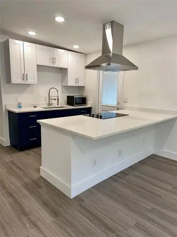 a kitchen with stainless steel appliances granite countertop a sink a stove and a refrigerator