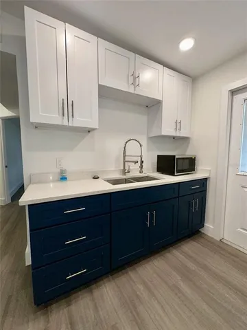 a kitchen with stainless steel appliances granite countertop a sink a stove and cabinets