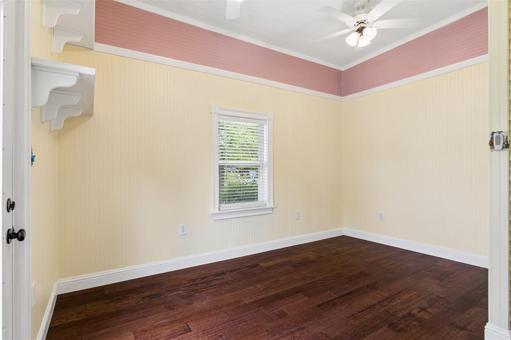 5824 Boone Street Sachse, TX 75048 - Photo 19 of 40 a view of an empty room with wooden floor and a window