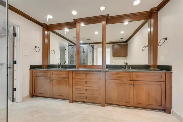 a bathroom with a double vanity sink and a mirror