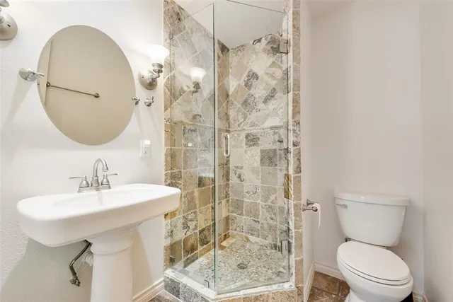 a bathroom with a sink toilet and shower