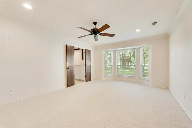 a view of a livingroom with a ceiling fan and window