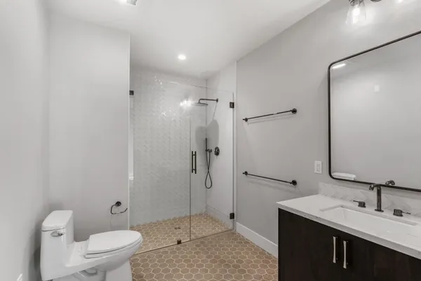 a bathroom with a sink toilet and shower