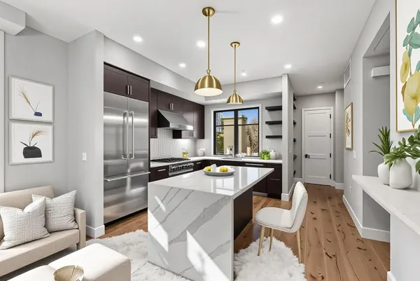 a kitchen with a table chairs refrigerator and microwave