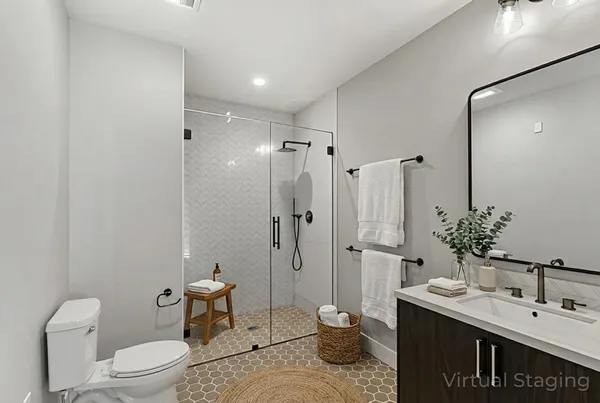 a spacious bathroom with a granite countertop sink toilet and shower