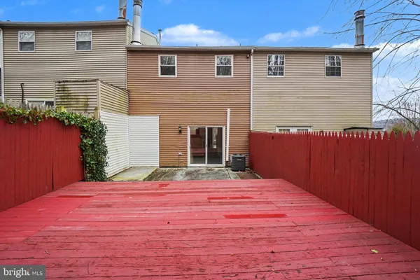 a wooden bench sitting in front of a building
