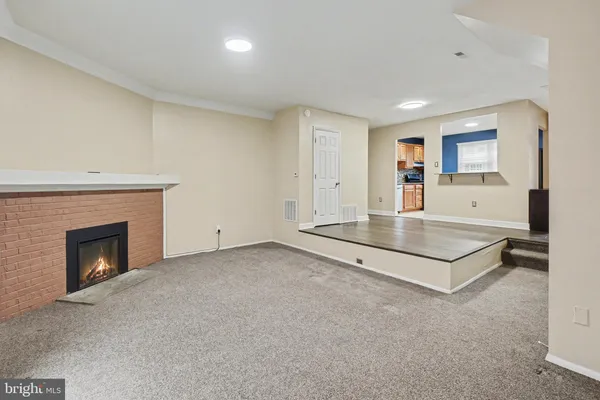 a view of empty room with fireplace
