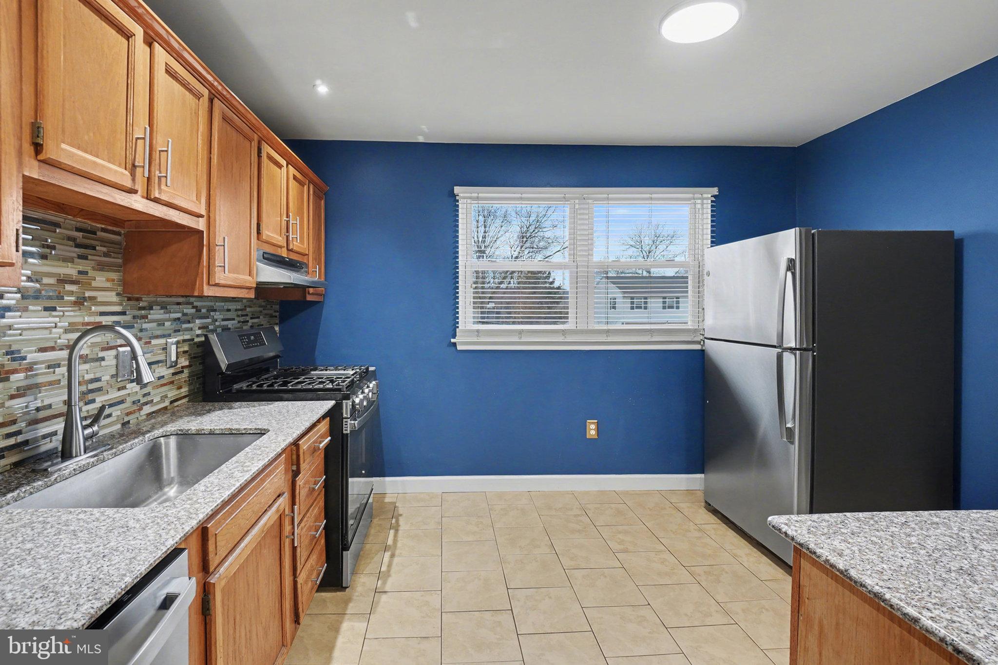 1280 Fox Run Reading, PA 19606 - Photo 8 of 23 a kitchen with stainless steel appliances granite countertop a refrigerator a sink dishwasher a stove with wooden cabinets