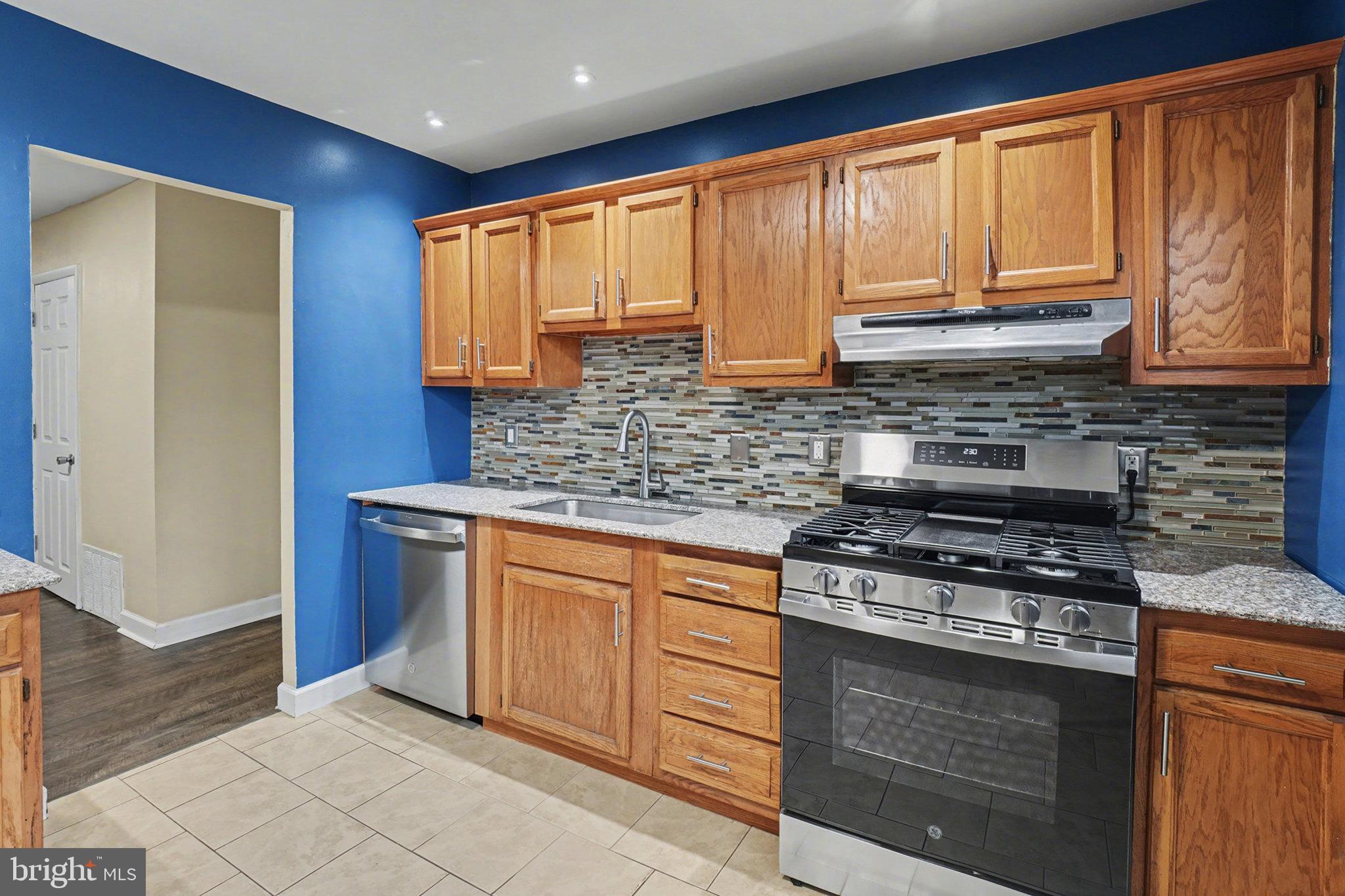 1280 Fox Run Reading, PA 19606 - Photo 9 of 23 a kitchen with stainless steel appliances granite countertop a stove a sink and a microwave