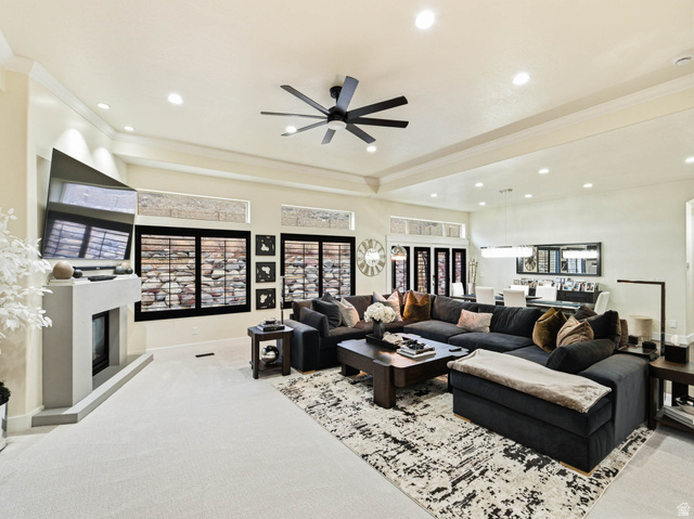 1154 Sunset Dunes Way Draper, UT 84020 - Photo 14 of 50 Living room featuring carpet flooring, a ceiling fan, a glass covered fireplace, recessed lighting, and ornamental molding