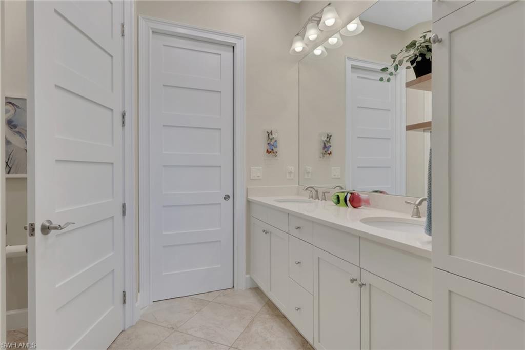 5752 Elbow Avenue Naples, FL 34113 - Photo 14 of 38 Full bath featuring double vanity and light tile patterned floors