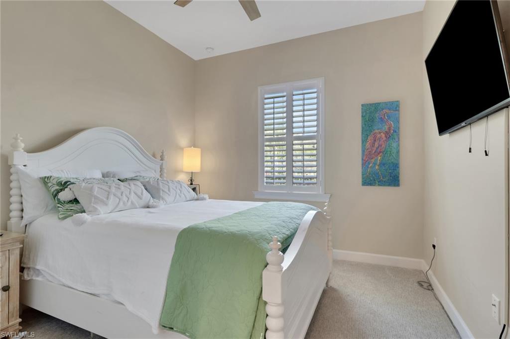 5752 Elbow Avenue Naples, FL 34113 - Photo 16 of 38 Bedroom with light colored carpet and ceiling fan