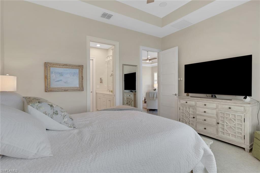 5752 Elbow Avenue Naples, FL 34113 - Photo 19 of 38 Bedroom with light colored carpet, ceiling fan, and ensuite bathroom