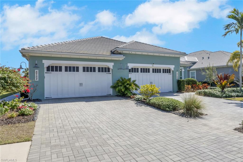 5752 Elbow Avenue Naples, FL 34113 - Photo 2 of 38 View of front facade with driveway, stucco siding, and a tiled roof