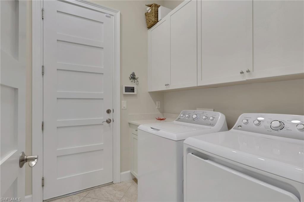 5752 Elbow Avenue Naples, FL 34113 - Photo 20 of 38 Laundry room featuring washing machine and clothes dryer and cabinet space