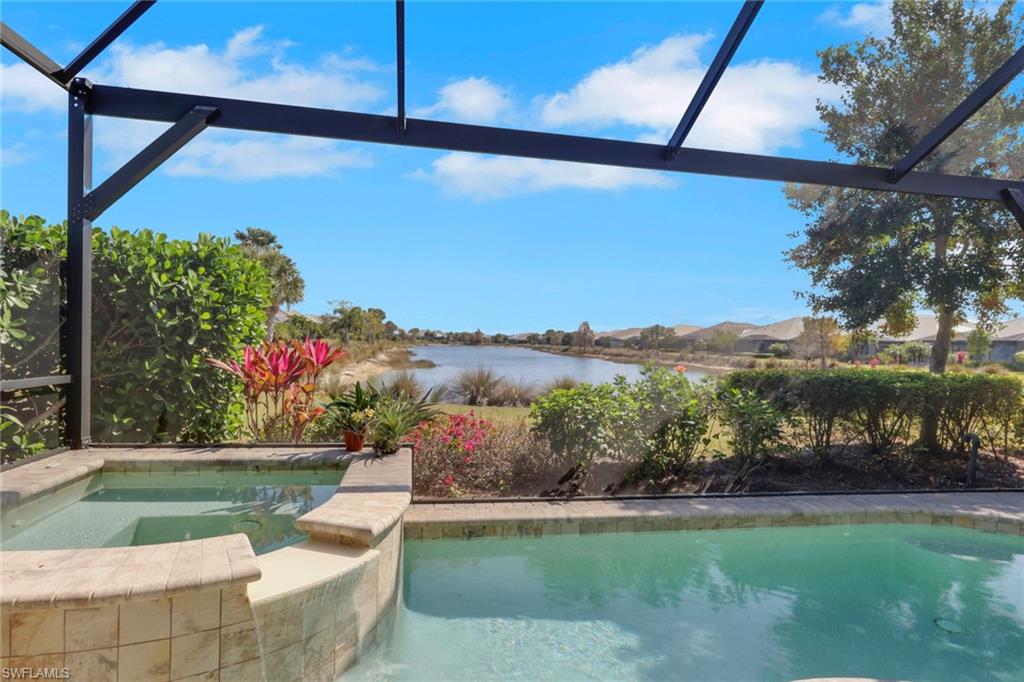 5752 Elbow Avenue Naples, FL 34113 - Photo 21 of 38 Combined pool / hot tub featuring glass enclosure, a water view, and a sunroom