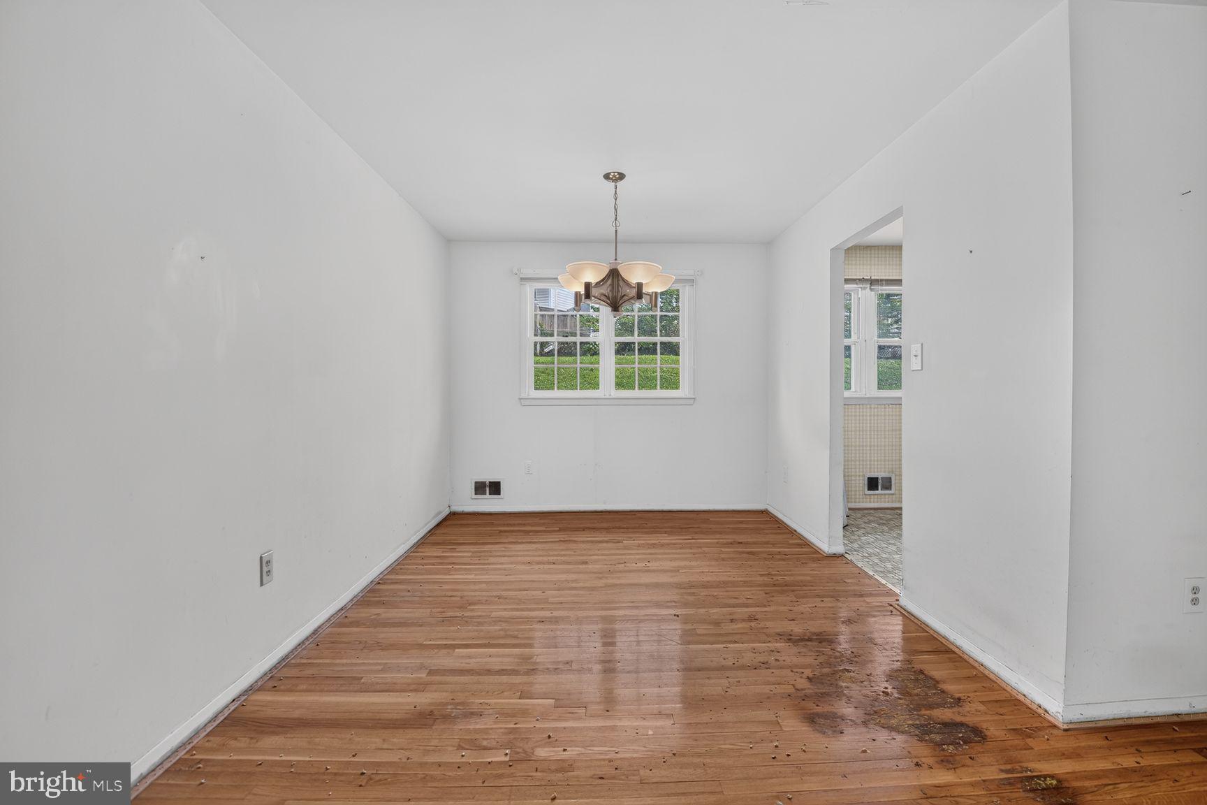 1326 Gresham Road Silver Spring, MD 20904 - Photo 13 of 30 a view of an empty room with window and chandelier fan