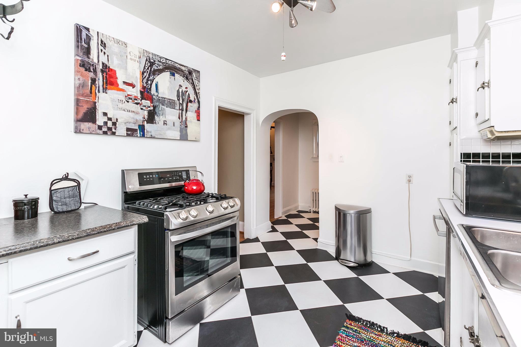 2412 Brambleton Road Baltimore, MD 21209 - Photo 14 of 30 a kitchen with stainless steel appliances a stove a sink and a refrigerator