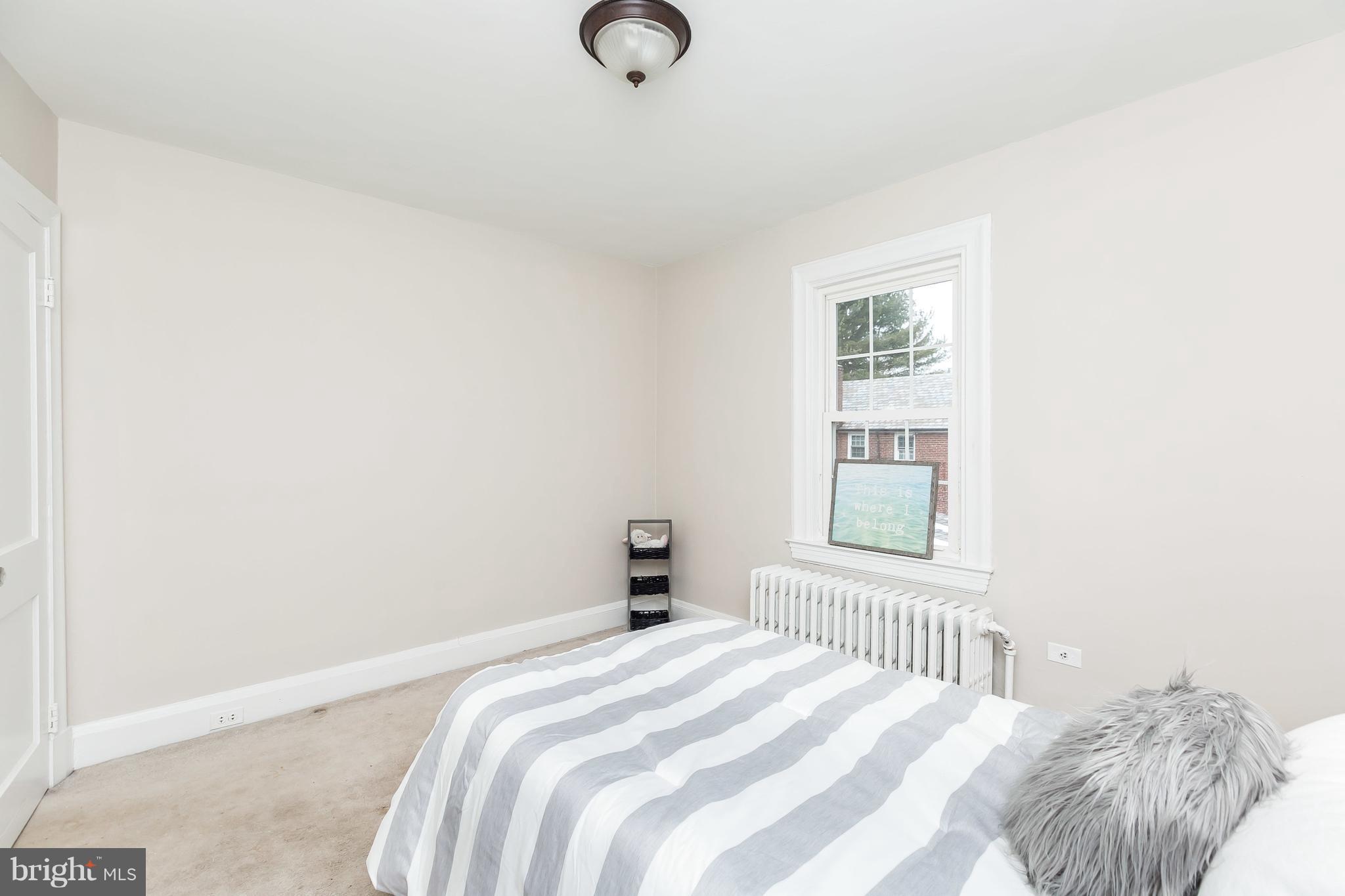 2412 Brambleton Road Baltimore, MD 21209 - Photo 22 of 30 a bedroom with a bed and a window