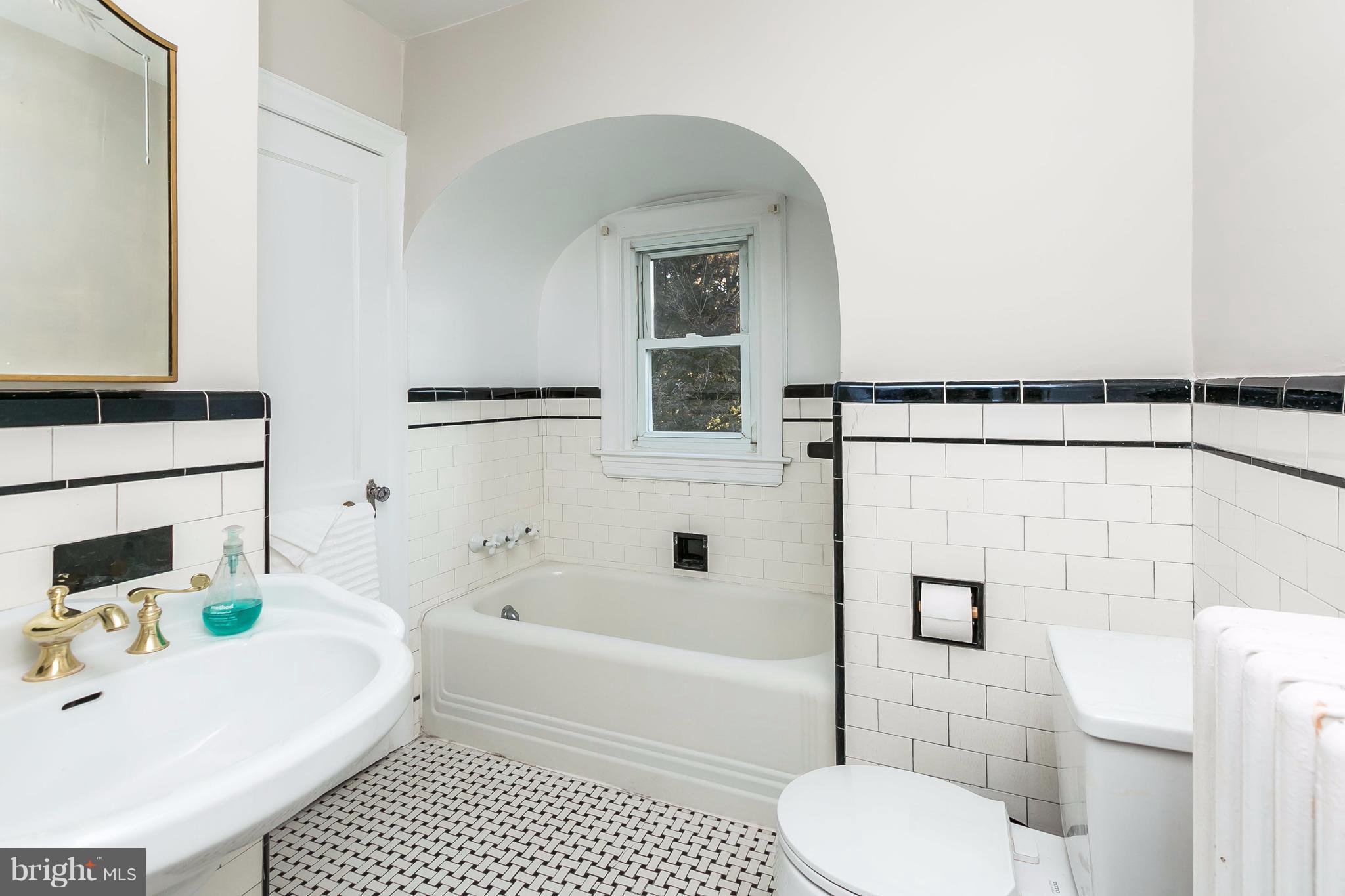 2412 Brambleton Road Baltimore, MD 21209 - Photo 23 of 30 a bathroom with a sink toilet and shower