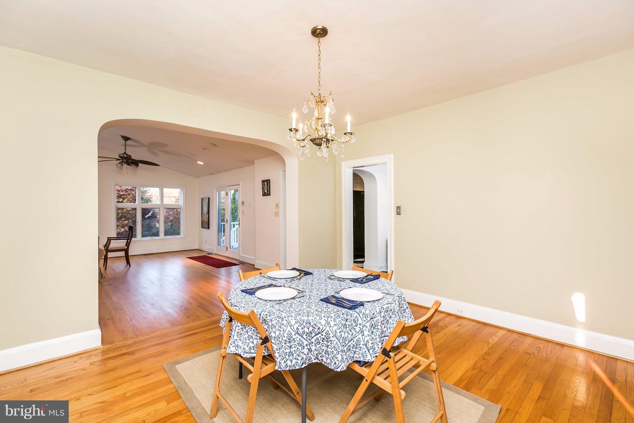 2412 Brambleton Road Baltimore, MD 21209 - Photo 7 of 30 a living room with dining table and a chandelier