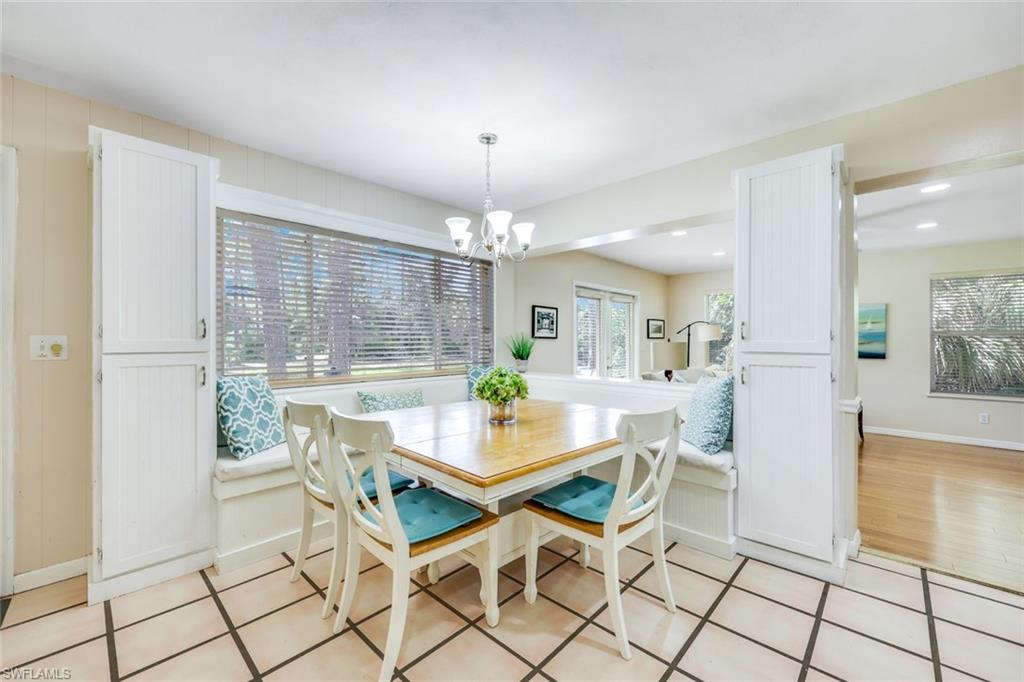131 Cajeput Drive Naples, FL 34108 - Photo 13 of 30 a view of a dining room with furniture wooden floor and chandelier