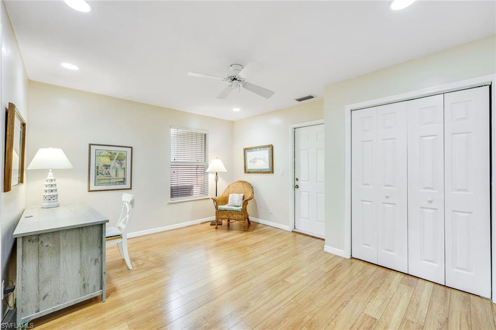 131 Cajeput Drive Naples, FL 34108 - Photo 19 of 30 a living room with furniture and a wooden floor