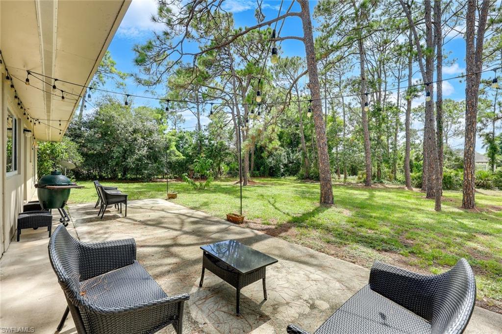 131 Cajeput Drive Naples, FL 34108 - Photo 20 of 30 a view of a patio with a yard
