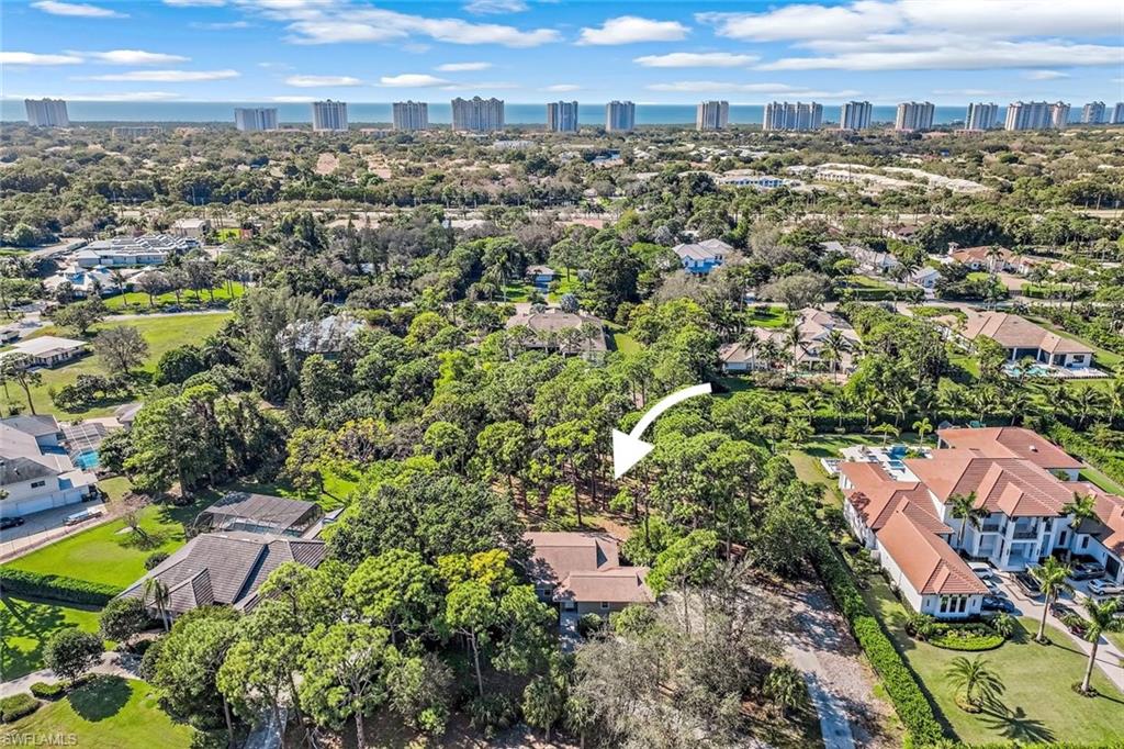 131 Cajeput Drive Naples, FL 34108 - Photo 2 of 30 an aerial view of a city with lots of residential buildings