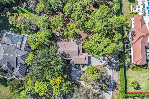 an aerial view of a house with garden space and street view