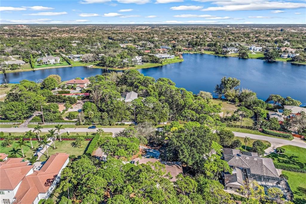 131 Cajeput Drive Naples, FL 34108 - Photo 25 of 30 an aerial view of a houses with a lake